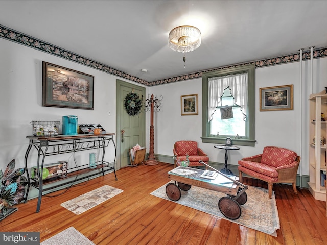 sitting room featuring baseboards and wood-type flooring