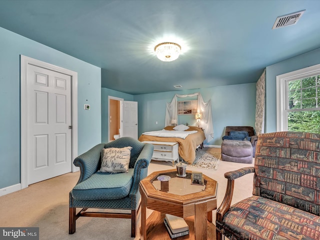 carpeted bedroom featuring visible vents and baseboards