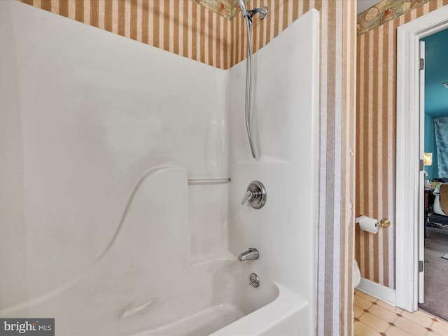 bathroom with tile patterned floors, baseboards, wallpapered walls, and bathtub / shower combination