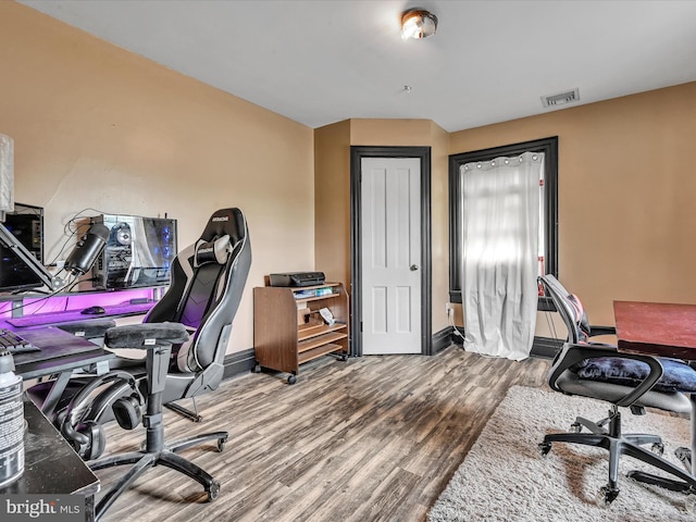 office area featuring visible vents, baseboards, and wood finished floors