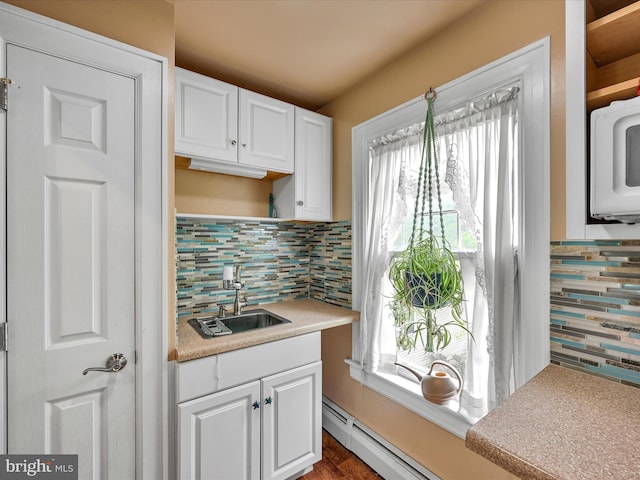 kitchen featuring white cabinets, plenty of natural light, and tasteful backsplash