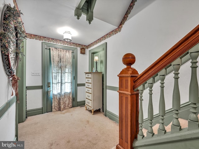 entrance foyer with stairway and carpet