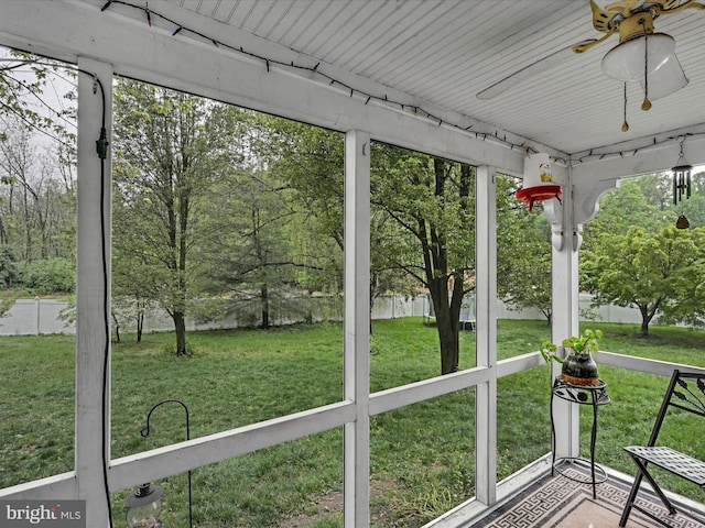 unfurnished sunroom with a ceiling fan