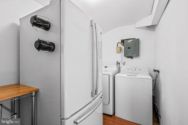 laundry area with electric panel, wood finished floors, laundry area, and washer and clothes dryer