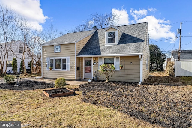 view of front of house featuring a shingled roof and fence