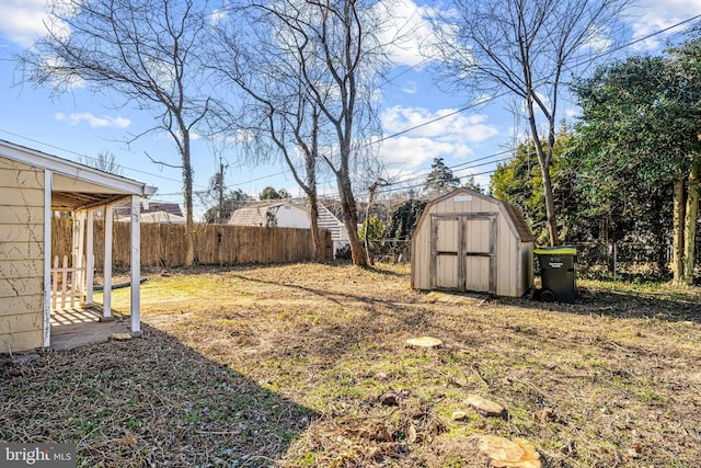 view of yard with an outdoor structure, a storage unit, and fence