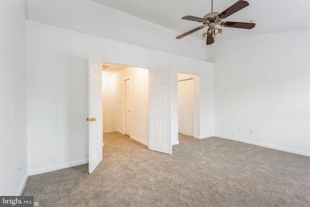 unfurnished bedroom with baseboards, carpet floors, and a ceiling fan