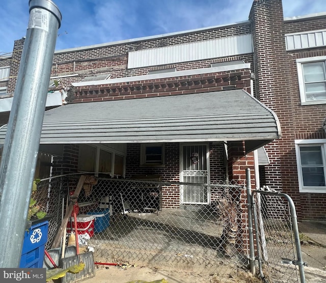 exterior space featuring fence and brick siding