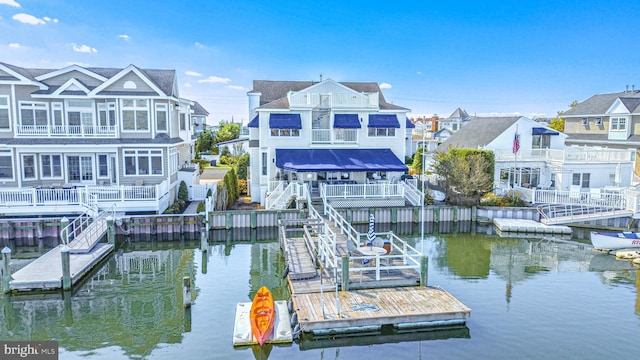 dock area featuring a water view and a residential view