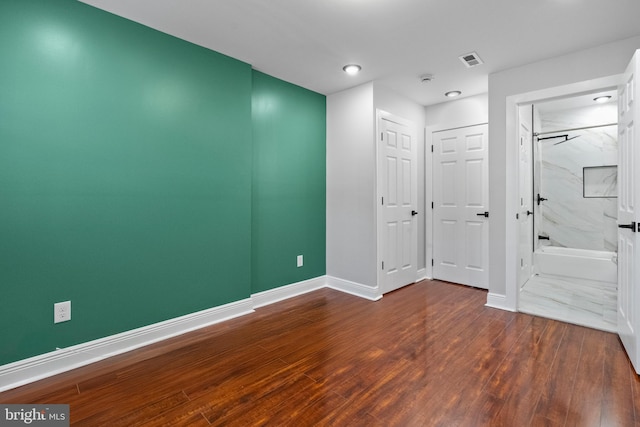 interior space with visible vents, baseboards, and wood finished floors