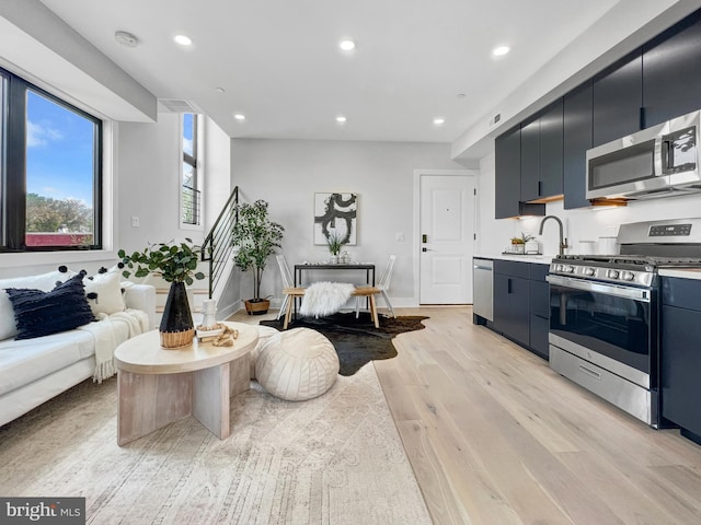 living area with recessed lighting, light wood-style floors, visible vents, and baseboards