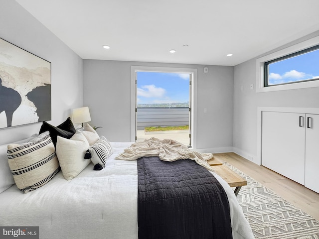 bedroom with recessed lighting, light wood-type flooring, baseboards, and access to outside