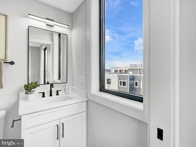 bathroom featuring toilet and vanity