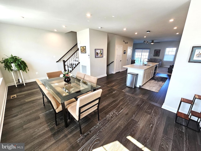 dining room with recessed lighting, stairway, baseboards, and dark wood-type flooring