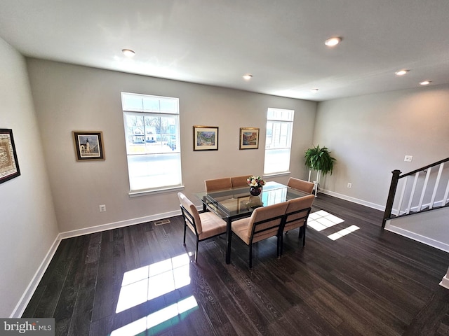 dining space with plenty of natural light, recessed lighting, dark wood-type flooring, and baseboards