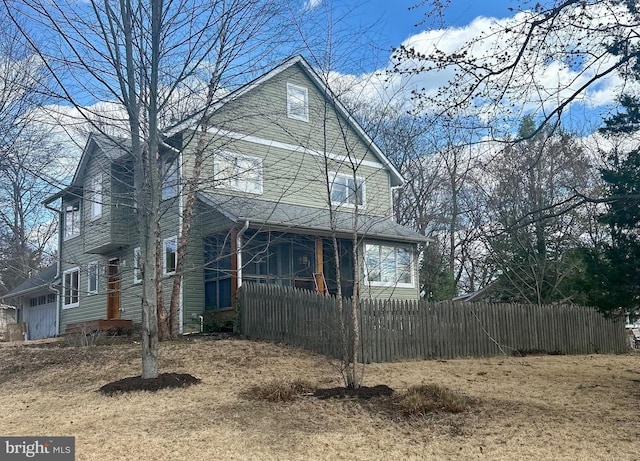 back of property featuring a fenced front yard