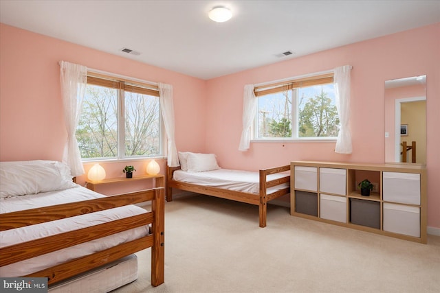 bedroom featuring light colored carpet and visible vents