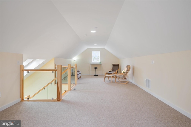 living area featuring carpet, visible vents, baseboards, lofted ceiling, and an upstairs landing