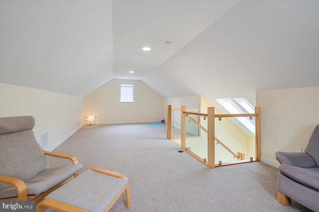 living area featuring visible vents, baseboards, carpet floors, an upstairs landing, and vaulted ceiling