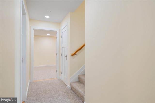 hallway with stairs, recessed lighting, baseboards, and carpet floors