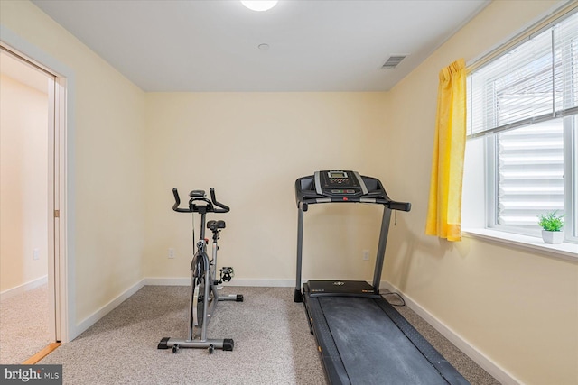 exercise room featuring visible vents, carpet, and baseboards