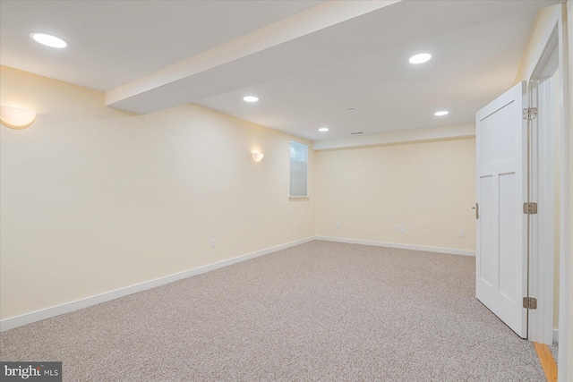 basement with recessed lighting, baseboards, and light carpet