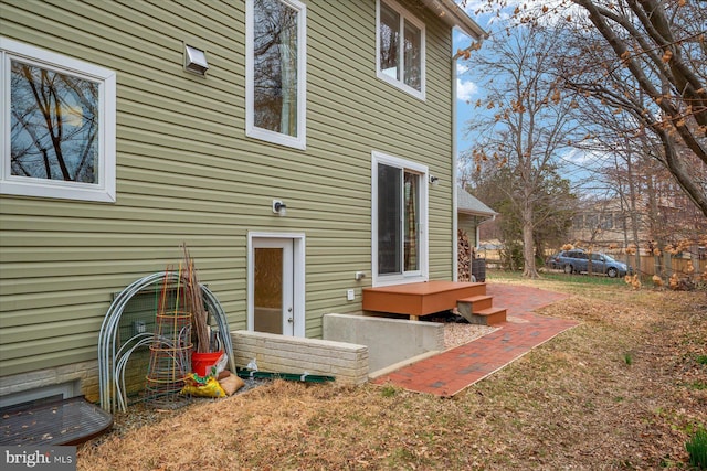 rear view of house with a lawn and fence