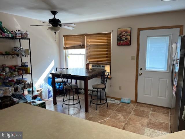 dining area featuring baseboards and a ceiling fan