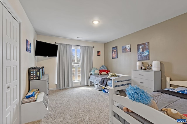 carpeted bedroom with a closet