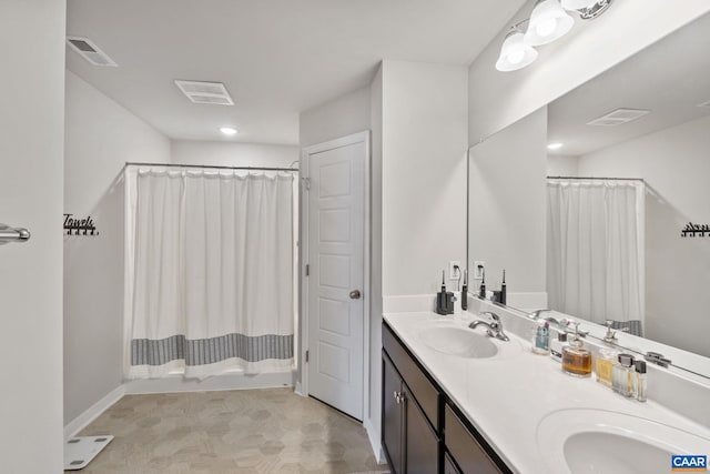 full bath with double vanity, visible vents, and a sink