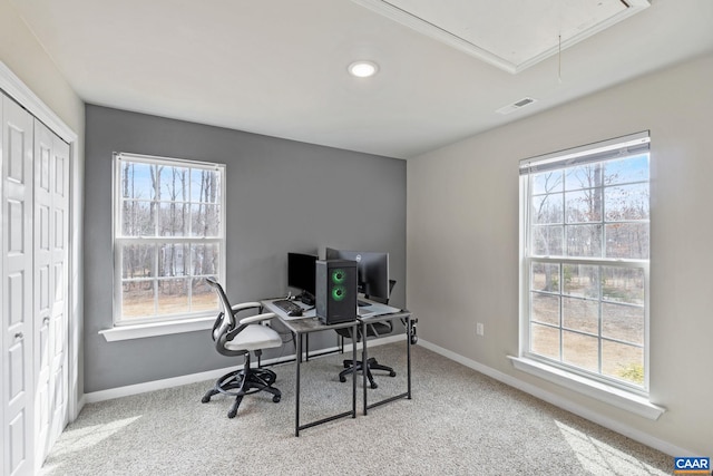 carpeted office space with visible vents, attic access, and baseboards