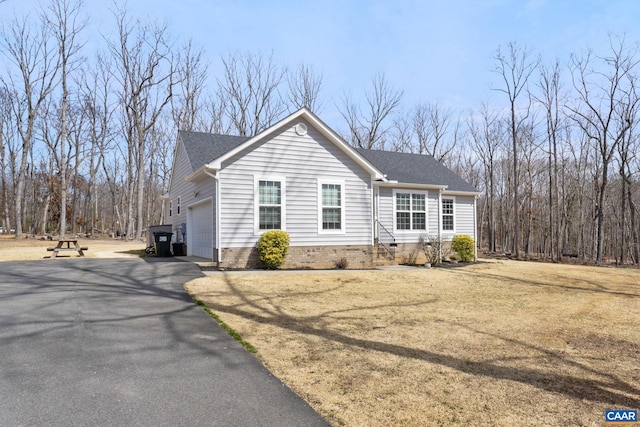 single story home featuring driveway and an attached garage