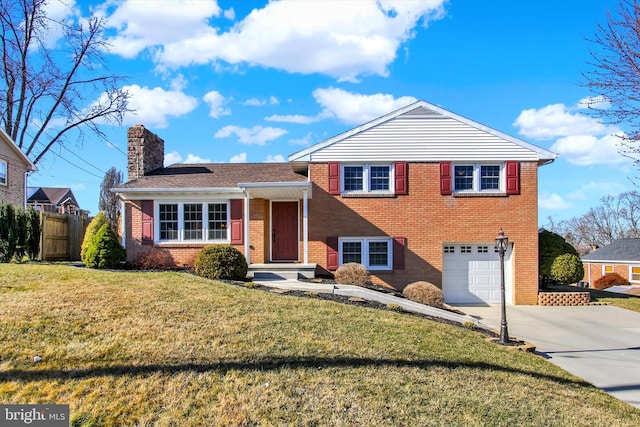 split level home with brick siding, fence, concrete driveway, a chimney, and an attached garage