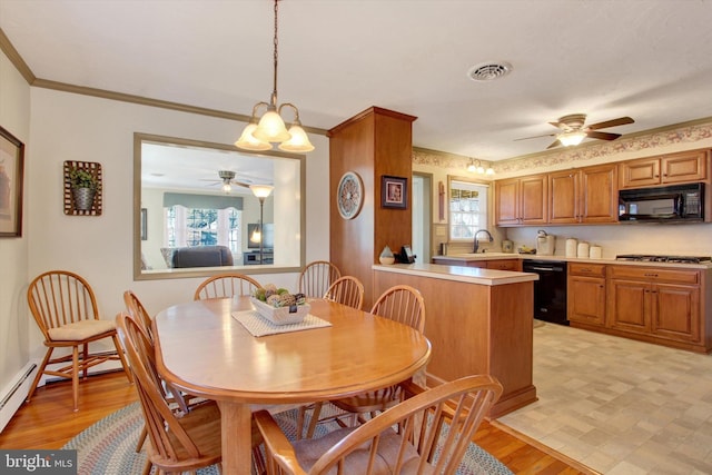 dining space featuring crown molding, light wood-style flooring, a healthy amount of sunlight, and visible vents