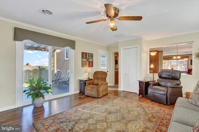 living room featuring plenty of natural light, visible vents, and wood finished floors