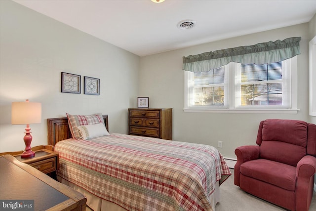 carpeted bedroom featuring visible vents and a baseboard radiator