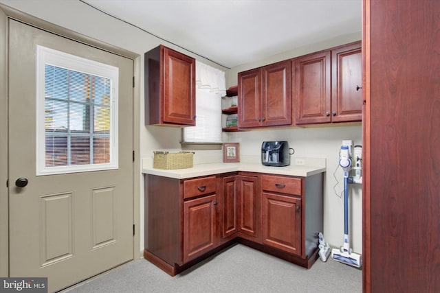 kitchen with light countertops, a healthy amount of sunlight, and open shelves