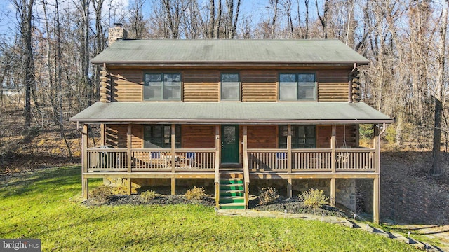 log-style house featuring a front lawn, stairway, log siding, covered porch, and a chimney