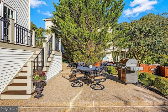 view of patio / terrace featuring stairway, outdoor dining area, and grilling area