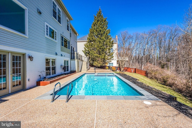 view of swimming pool featuring a fenced in pool, fence, stairs, and a patio area