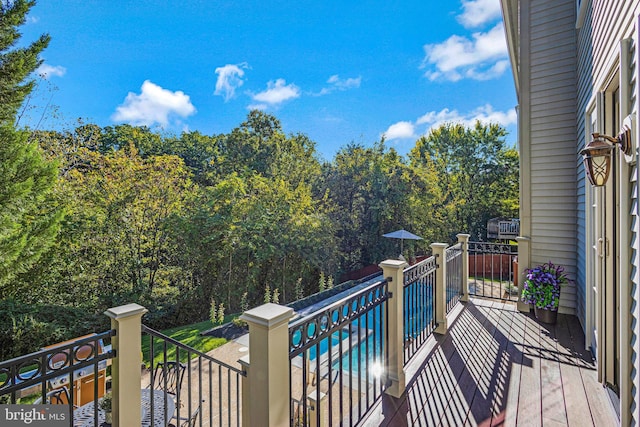 balcony with a pool with connected hot tub