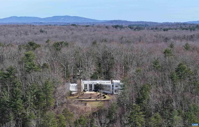 drone / aerial view with a mountain view and a forest view