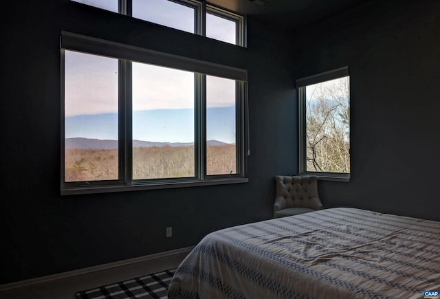 bedroom with a mountain view and baseboards