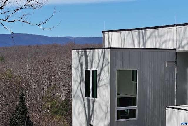 view of side of home featuring a mountain view