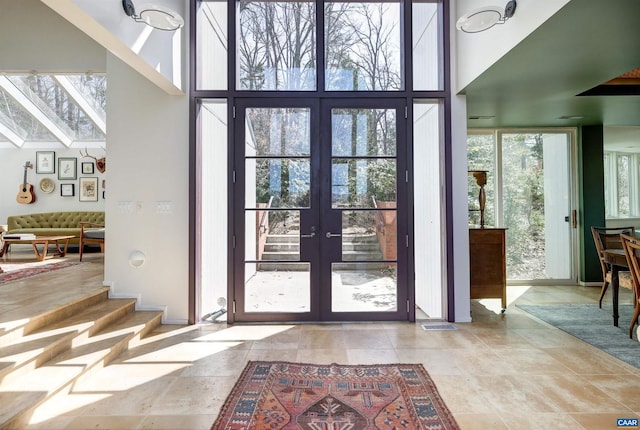 doorway featuring french doors and a towering ceiling