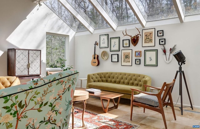 sitting room featuring a skylight and baseboards