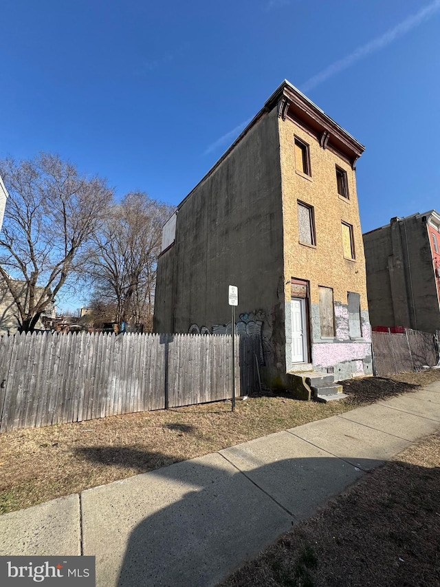 view of building exterior featuring fence