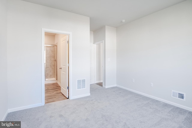 unfurnished bedroom with baseboards, visible vents, and carpet floors