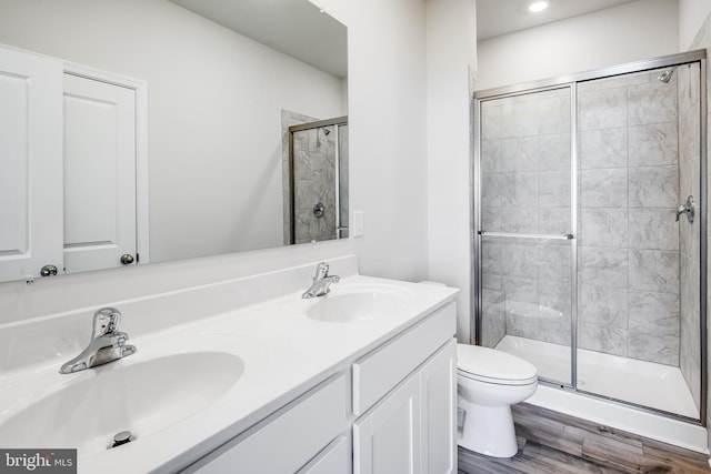 full bath with a shower stall, toilet, and a sink