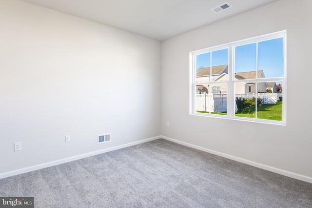 unfurnished room with visible vents, carpet floors, and baseboards